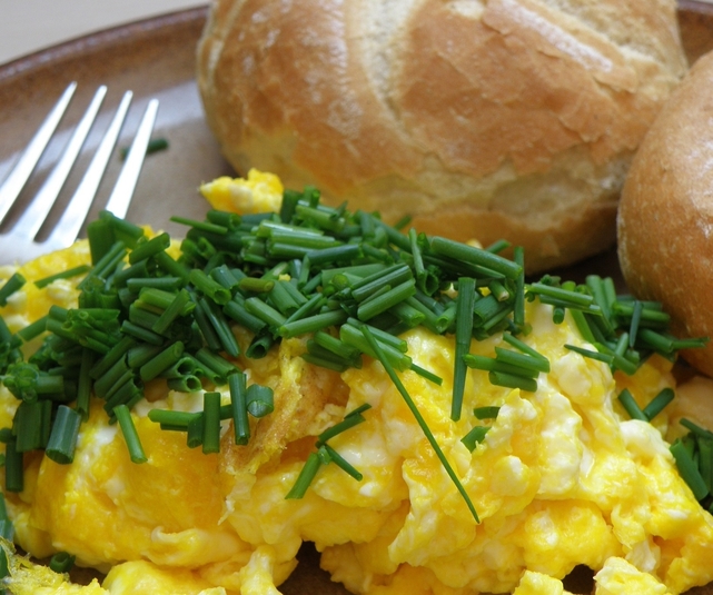 Chives on top of scrambled eggs